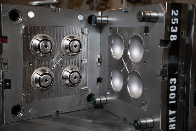 CNC machine cutting a precision steel mold cavity