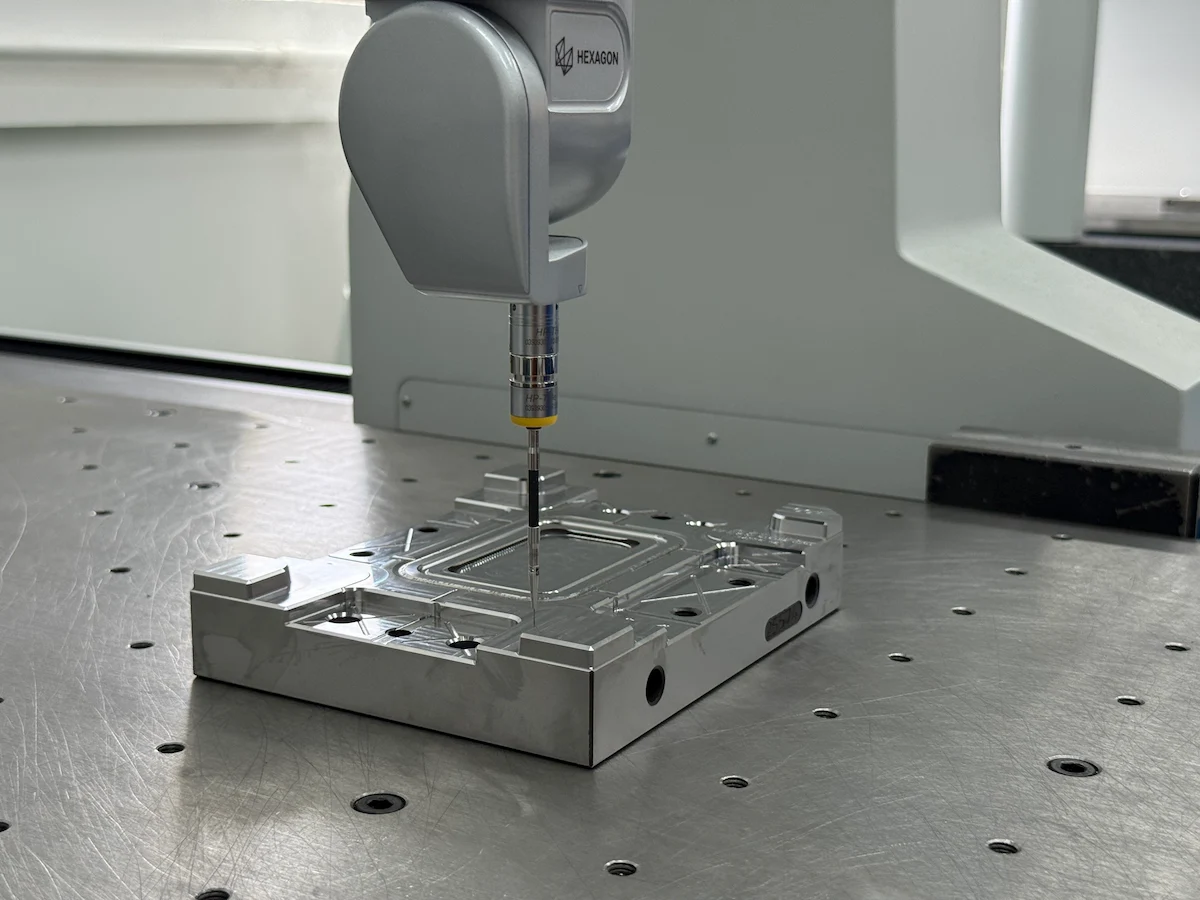 Coordinate measuring machine inspecting a first-article molded sample