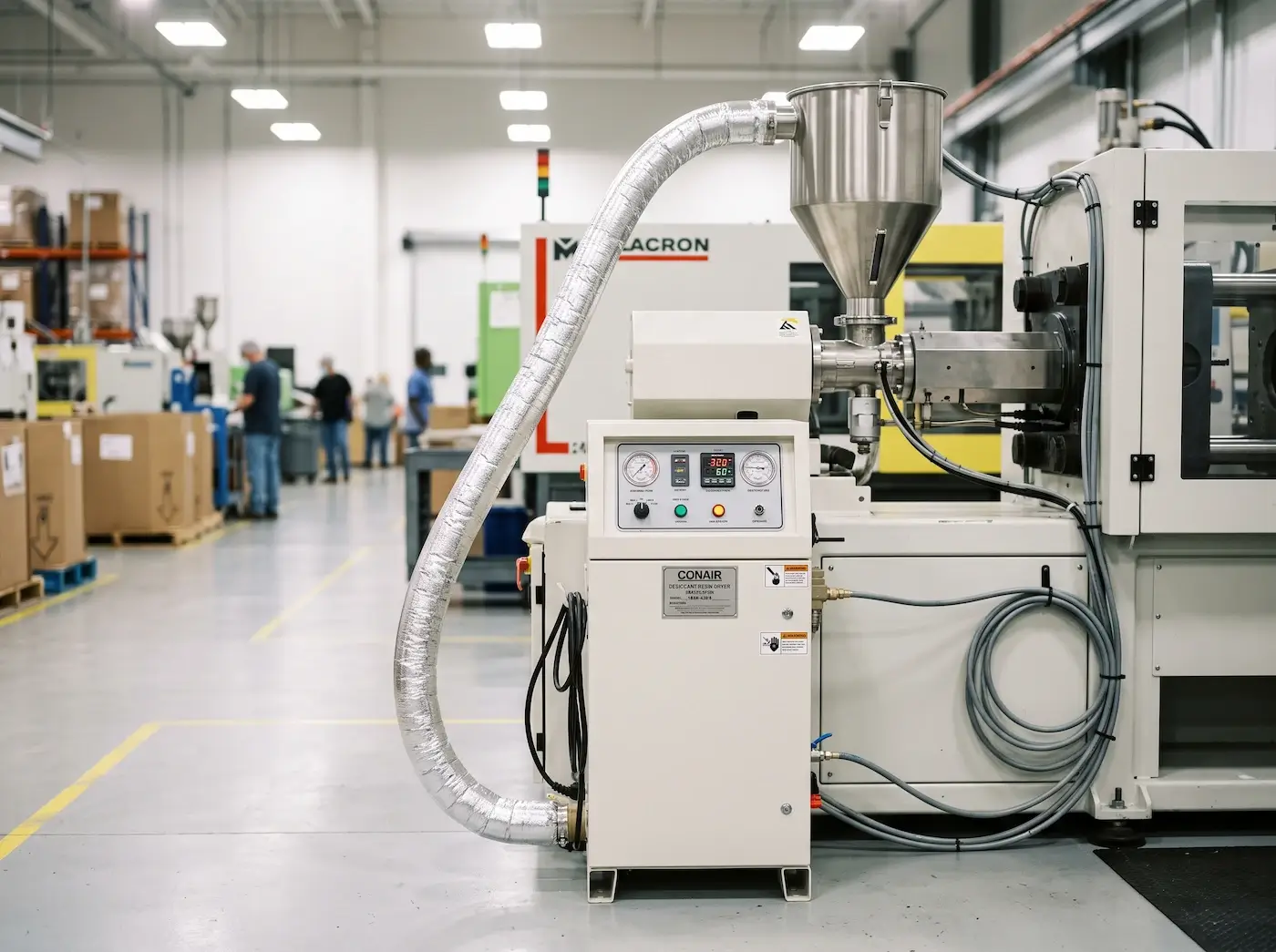 Desiccant resin dryer connected to a hopper on an injection molding machine