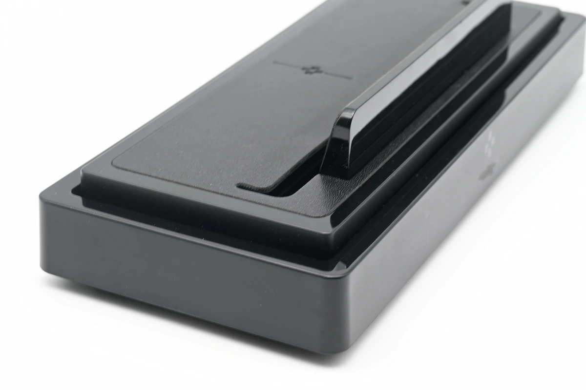 Several overmolded plastic parts with different TPE and TPU grip materials laid out for comparison