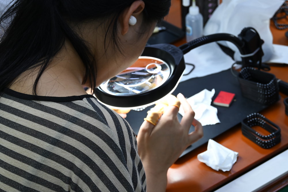 Quality inspector examining a molded plastic part for surface defects
