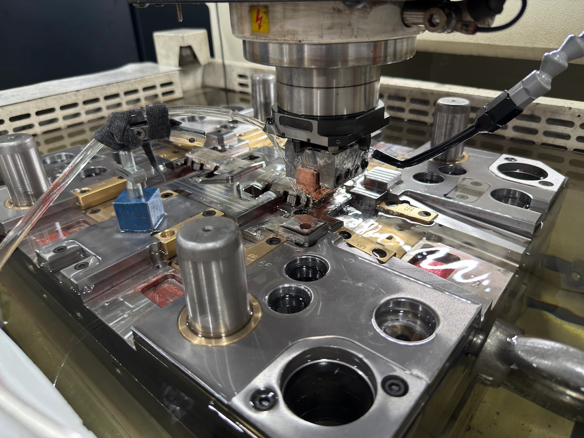Sinker EDM machine burning fine detail into a mold cavity