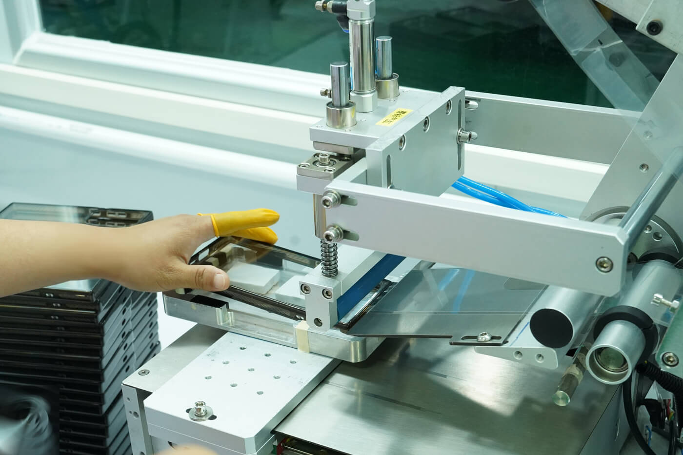 Clear plastic parts with protective film being packaged for shipment
