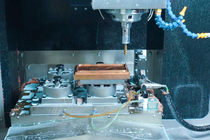 High-speed CNC machine cutting a mold core