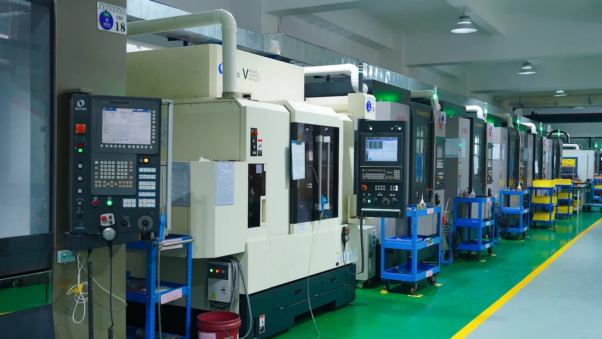 Wide view of an in-house mold making workshop with CNC machines running