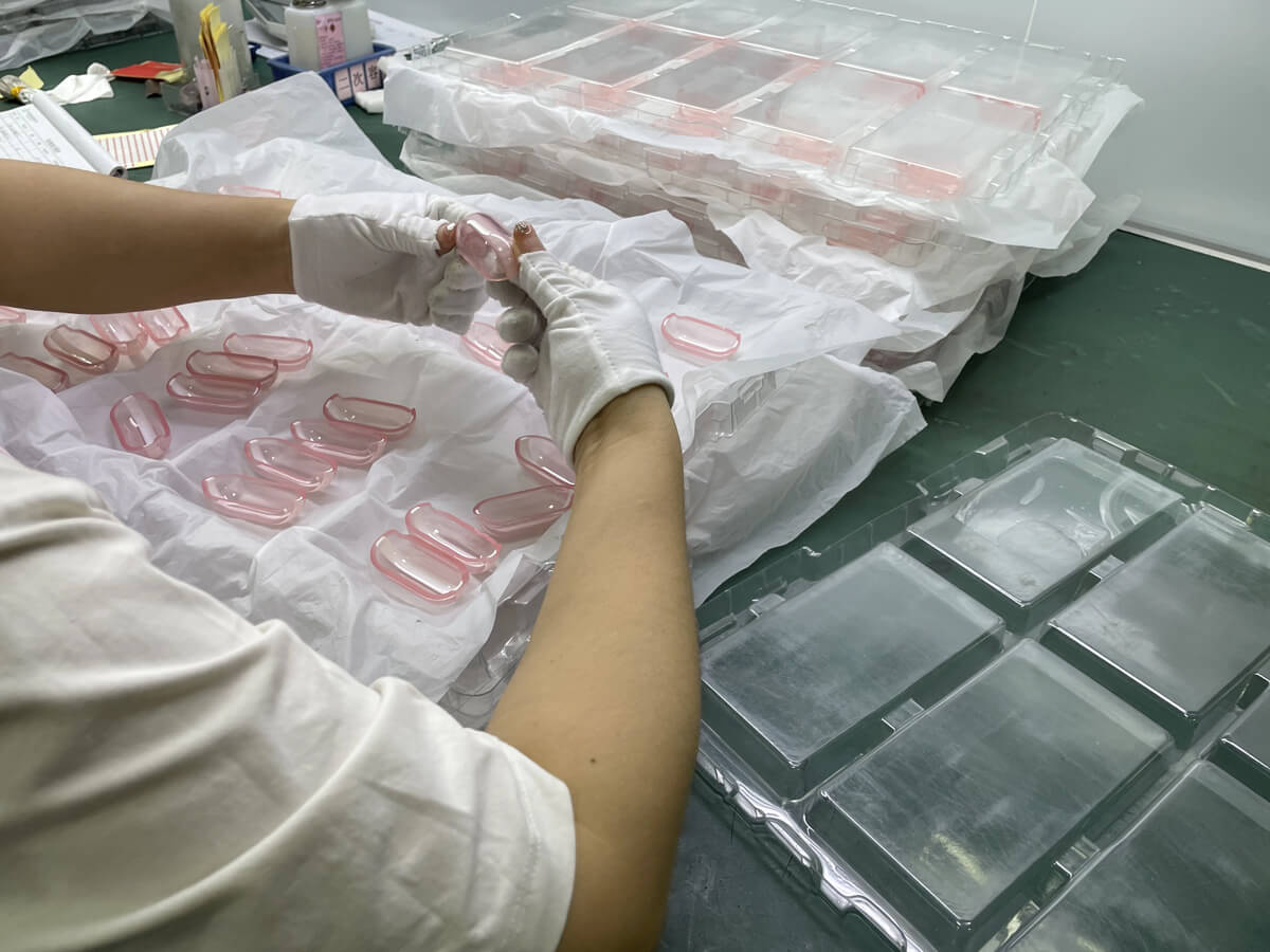 Quality inspector performing AQL sampling inspection on injection molded parts