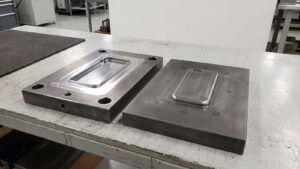 Open injection mold core and cavity halves on a clean bench ready for T1 trial inspection