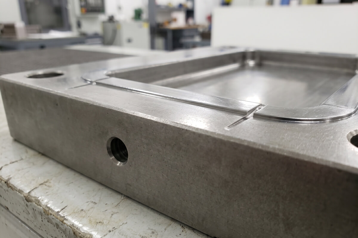 Close-up of shallow vent slots machined into an injection mold parting surface