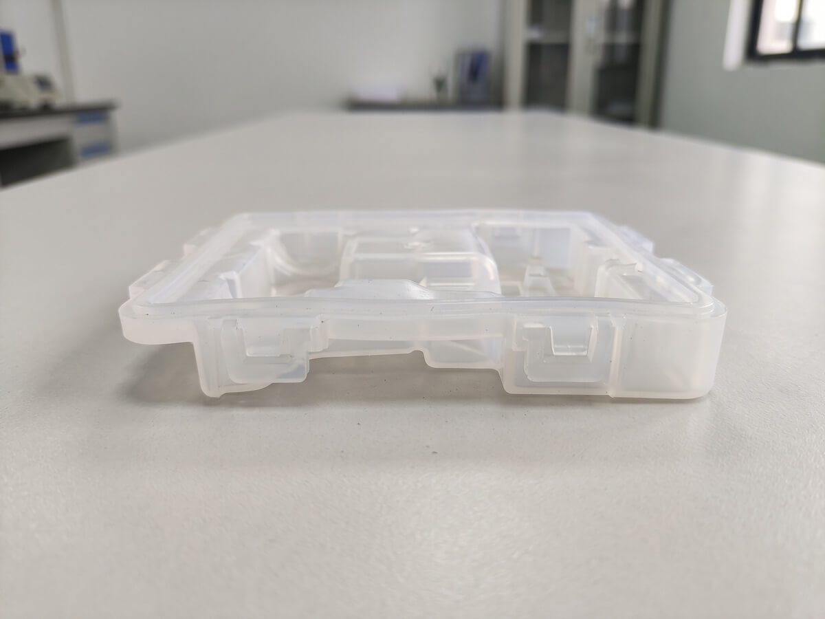 Comparison of a molded part requiring slide tooling versus one released by LSR's elastic deflection